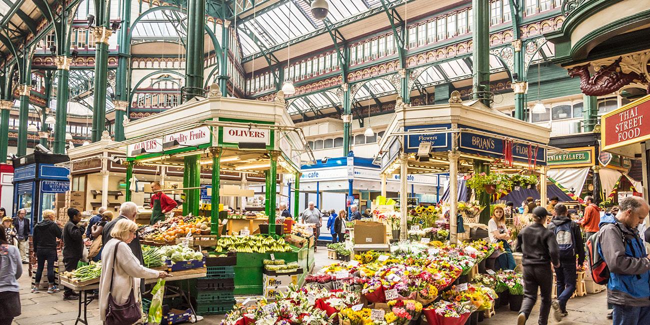 Flower and fruit stalls under the roof of Kirkgate Market.