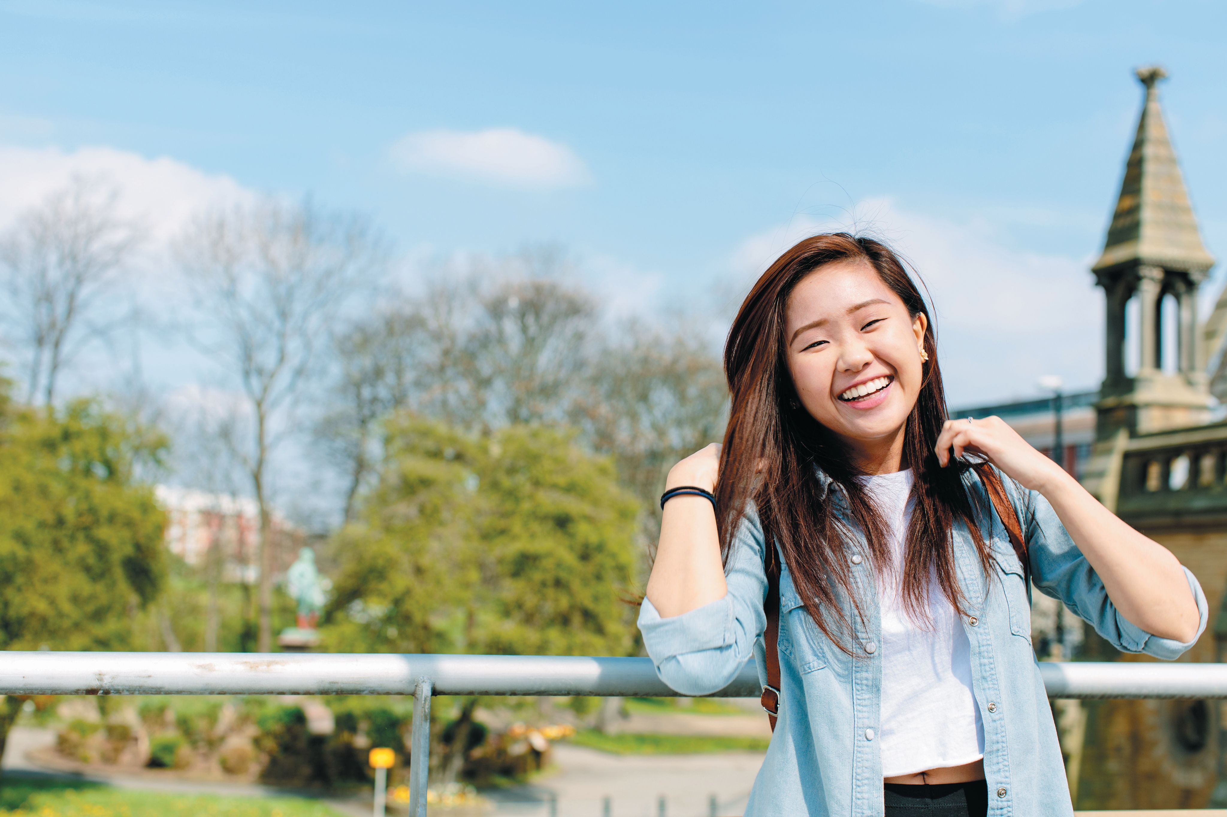student smiling with view over campus