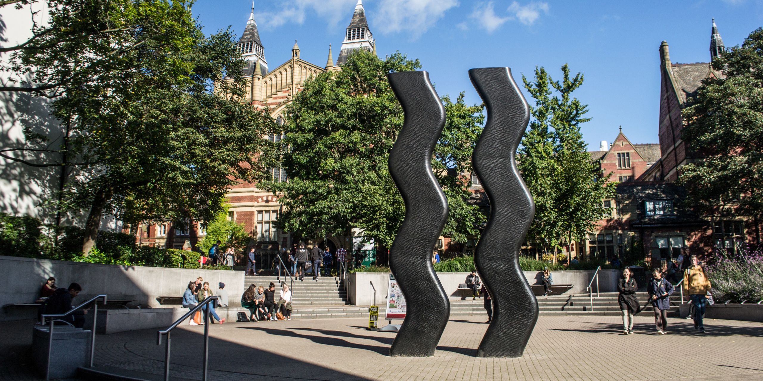 Sign for Art sculpture, two tall waved columns, on the University of Leeds campus. 