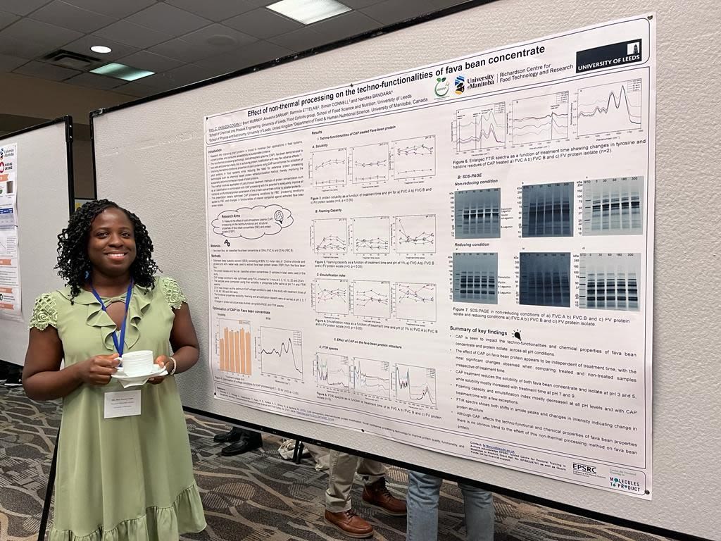 A photo of PhD student Mary Okeudo-Cogan in front of an academic presentation