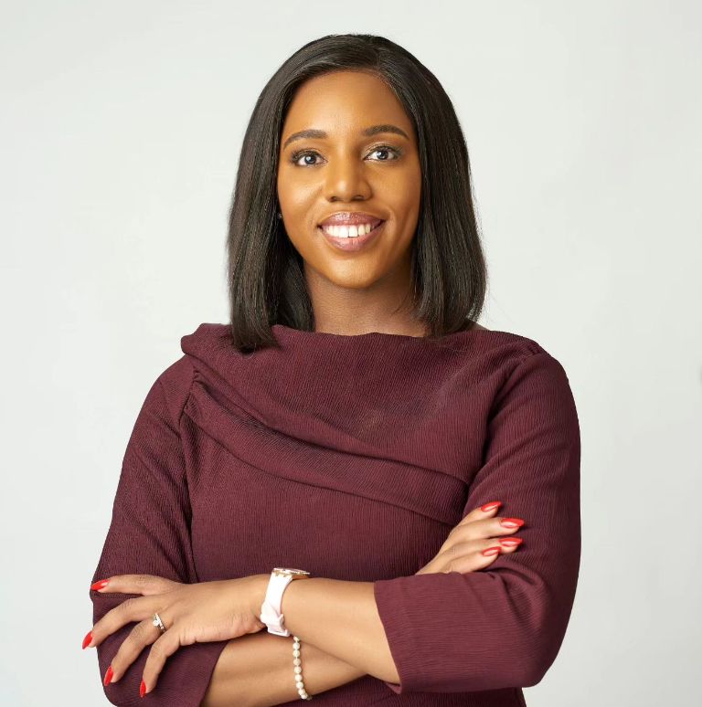 Anna Ekeledo with arms crossed looking at camera