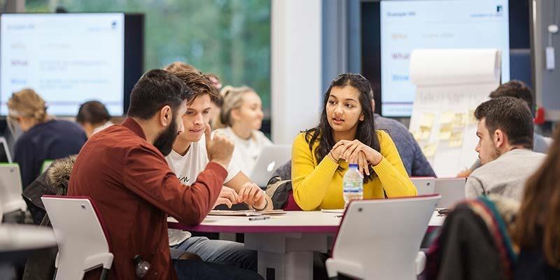 A group of students studying and chatting.