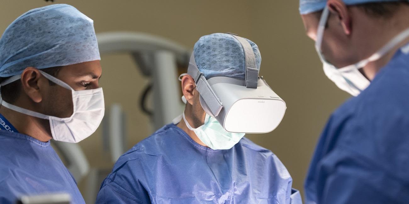 A group of surgeons, one of whom wears a virtual reality mask.