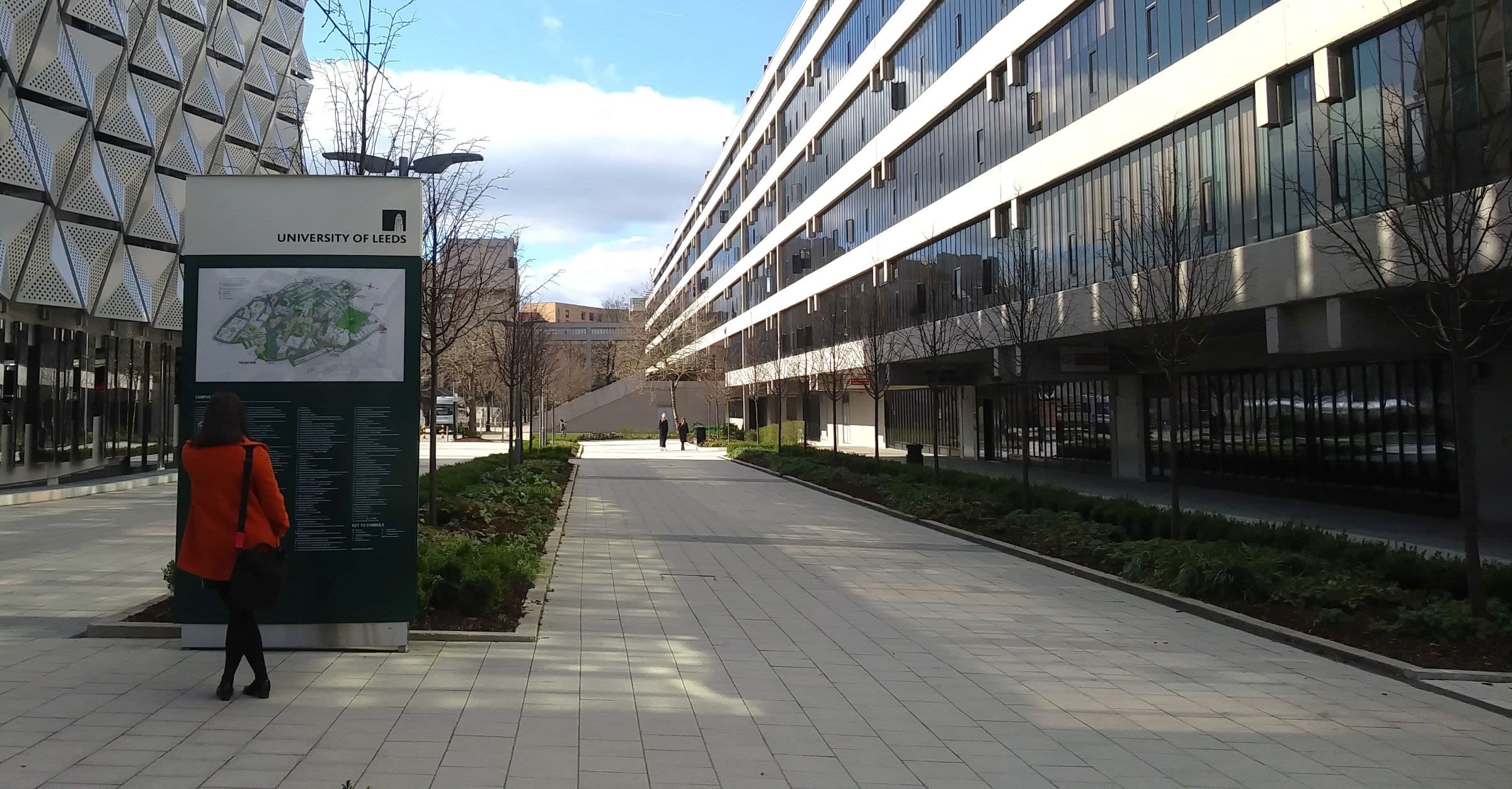 Person looking at a map in front of a long building