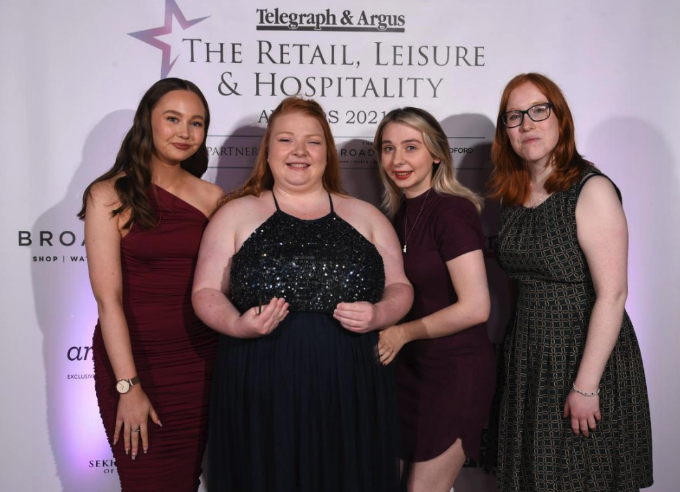 Katie Mahon with members of her team after winning at the Telegraph And Argus Retail, Leisure and Hospitality Awards