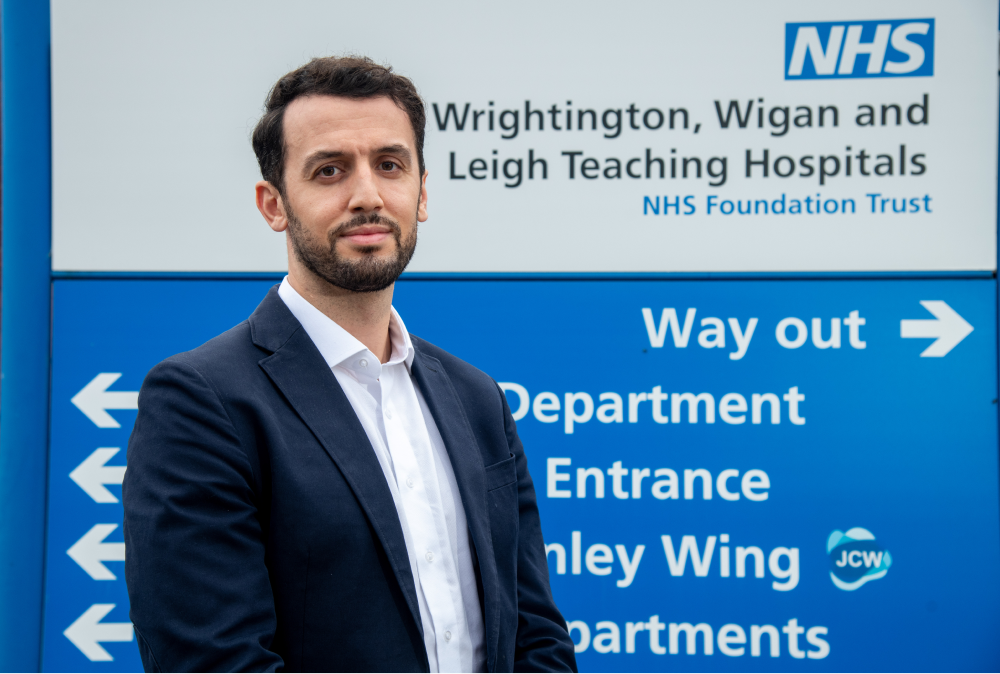 Moez stands in front of the welcome sign at Writhington Hospital