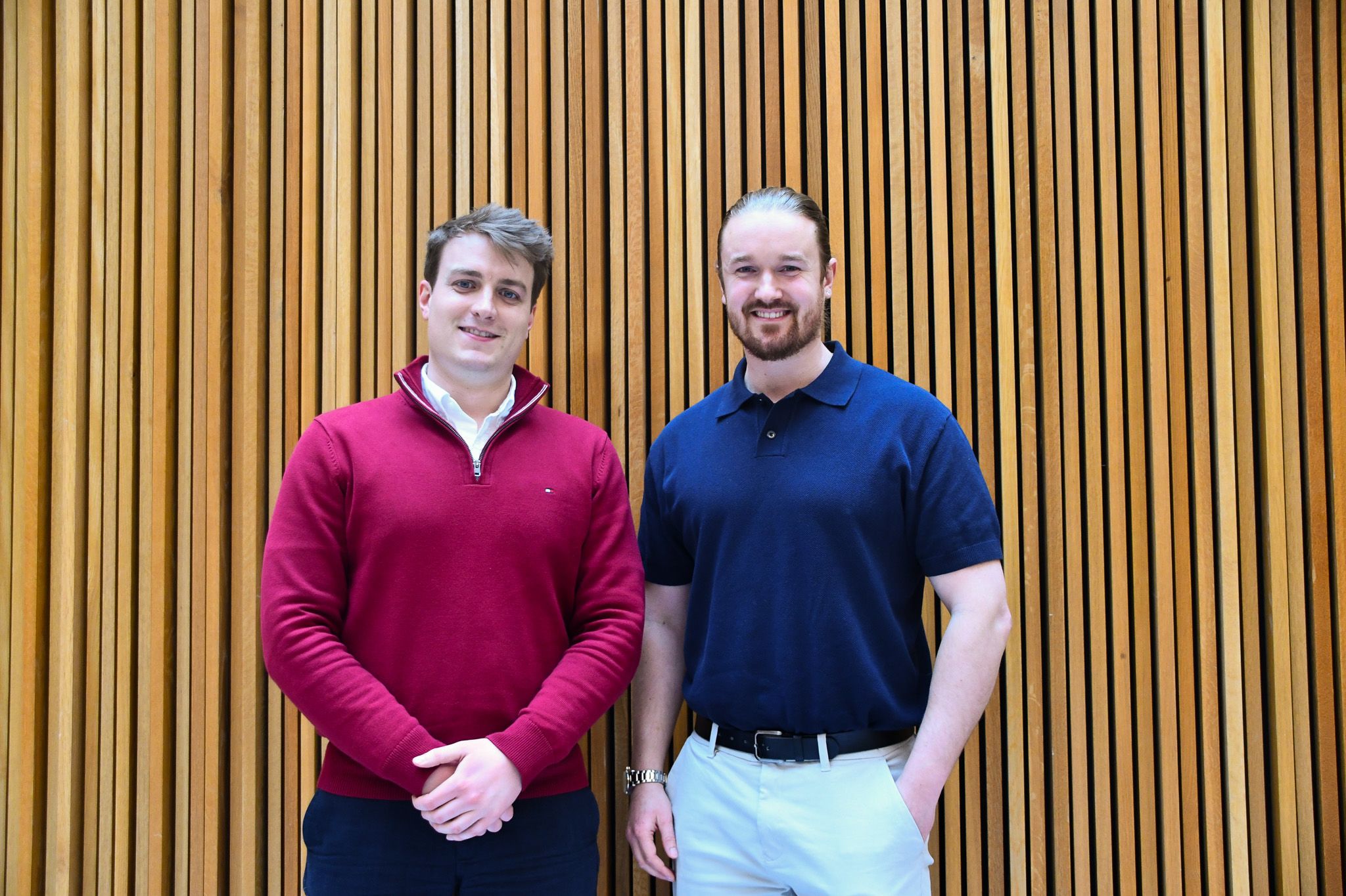 Lyndon Timings-Thompson and James McBride of We are Social Enterprise Recritment stand together in front of the Nexus building, smiling at the camera.