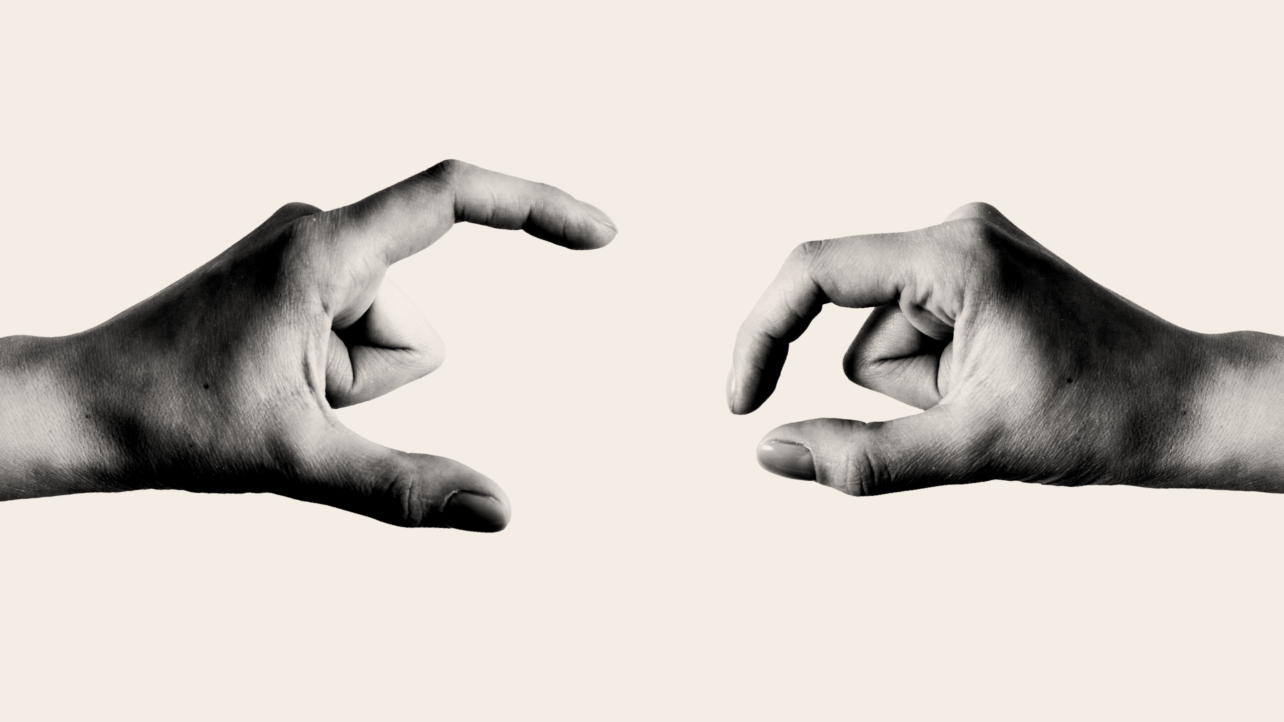 Two hands gesturing as if to demonstrate the size of something using the thumb and forefinger