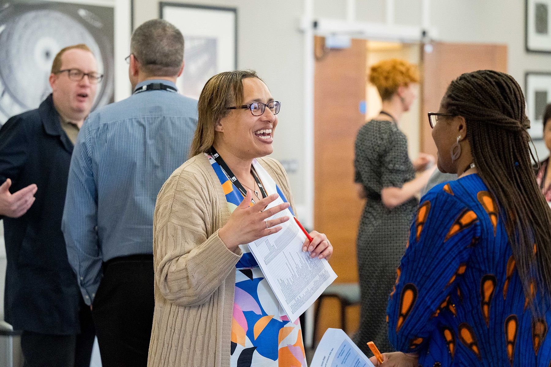 Dionne talking to a colleague in a workshop environment.