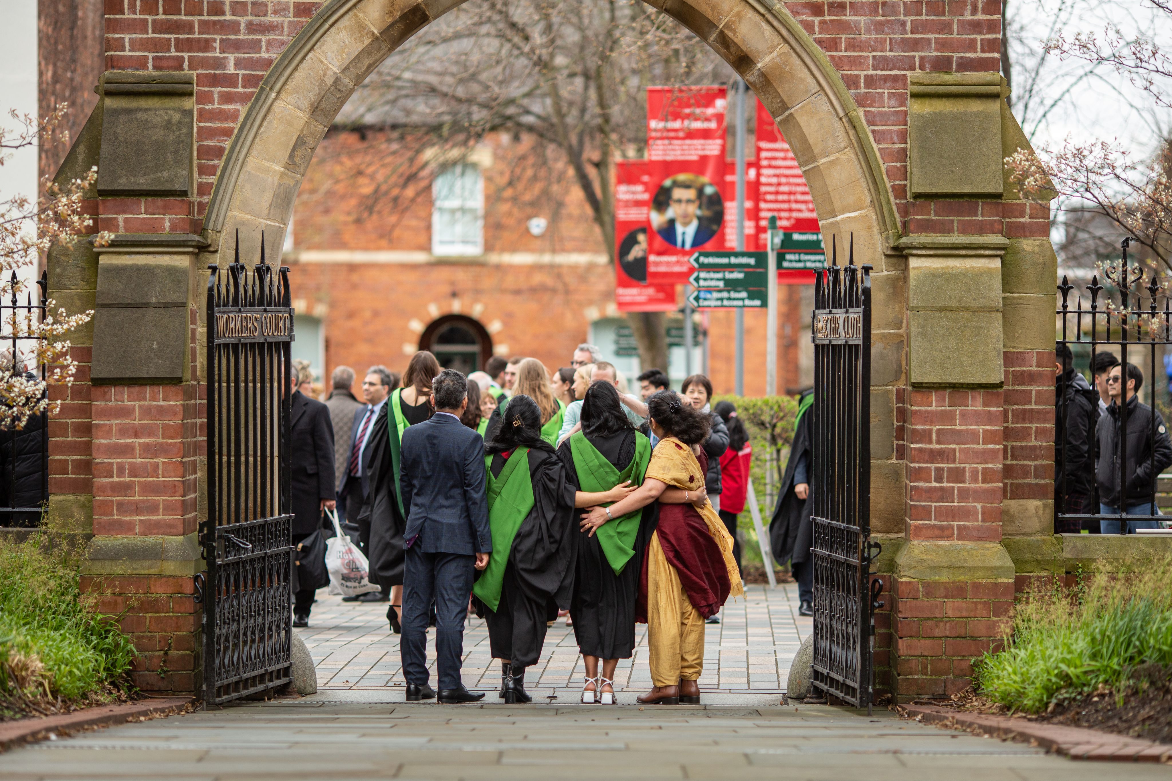 Family pose for photo on campus during graduation