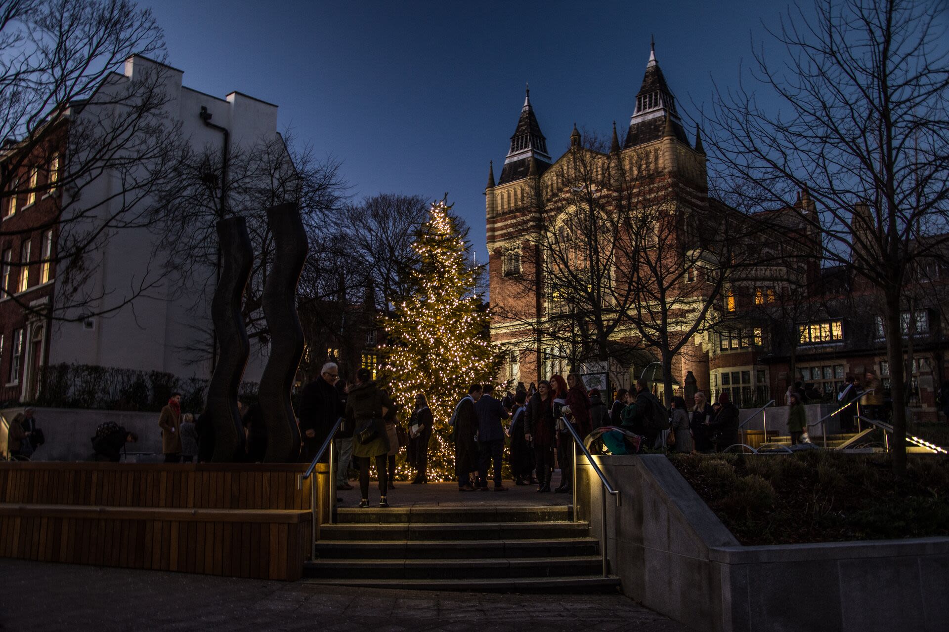 Graduates pose outside the Great Hall during graduation