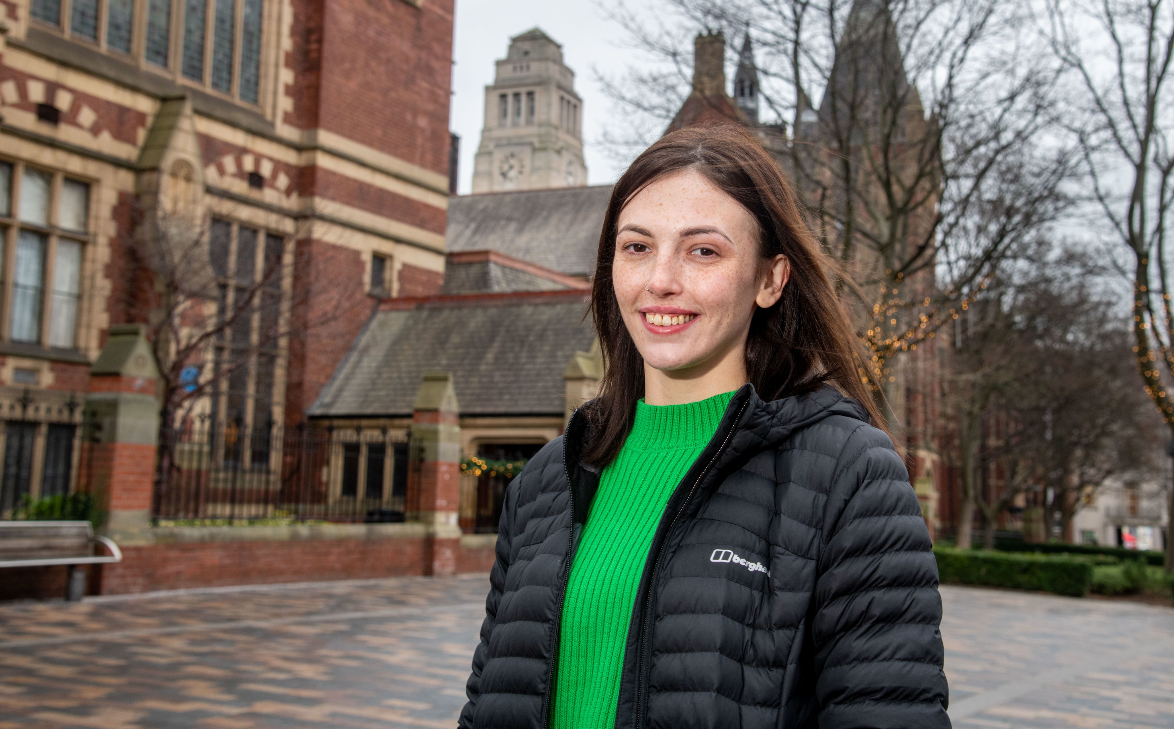Emillie in front of the Great Hall with Parkinson Tower visible in the background