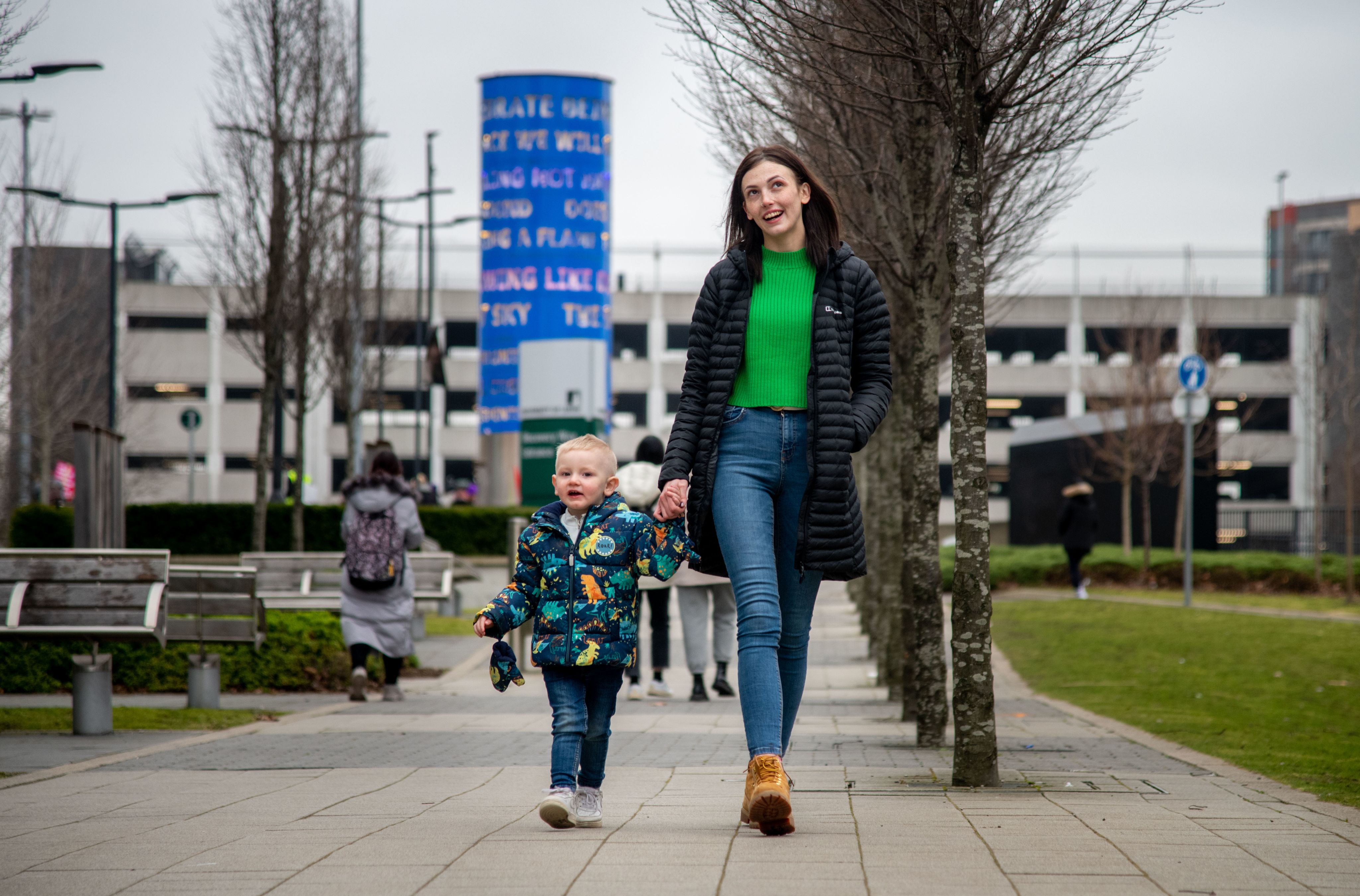 Emillie with son walking down toward Campus from town.