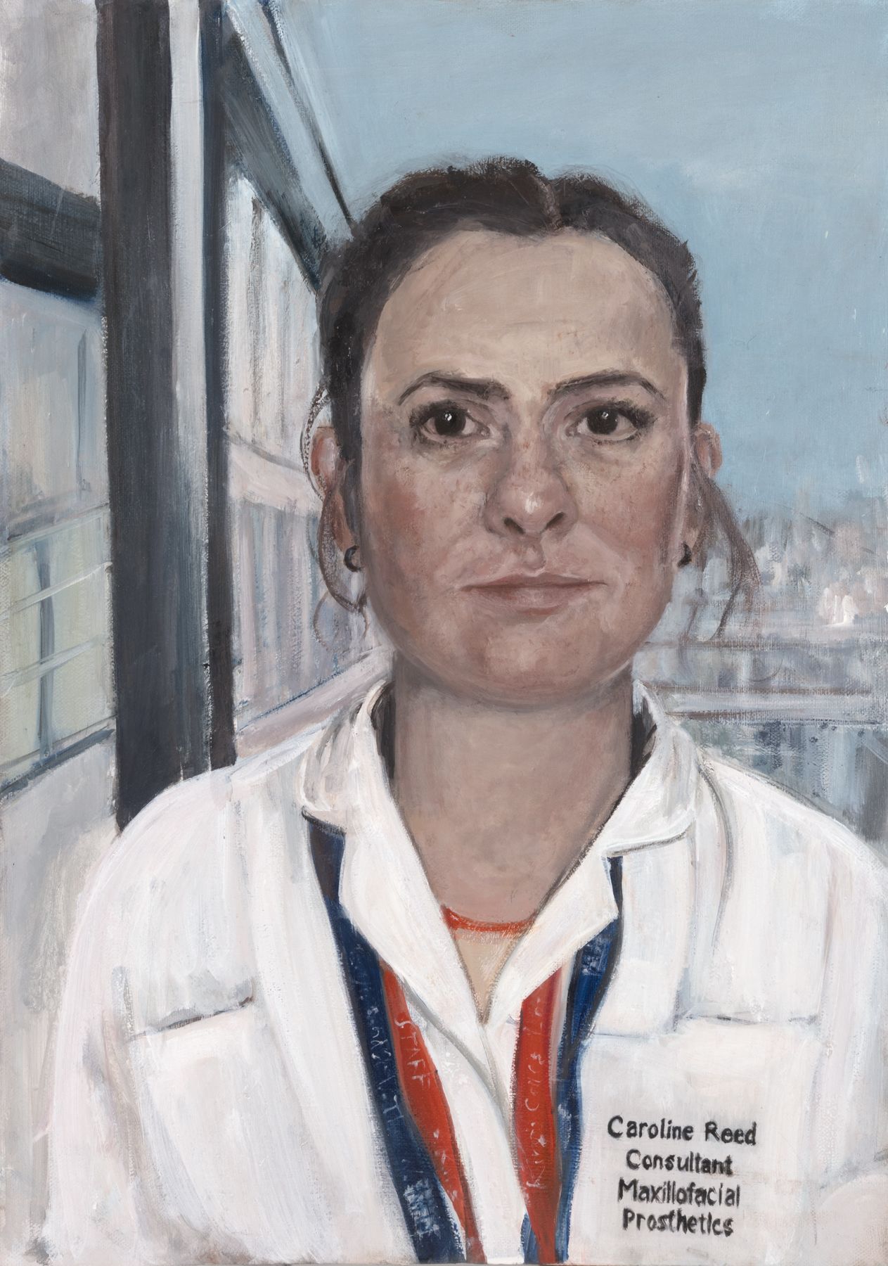 Portrait of Caroline Reed in a white medical uniform wearing lanyards