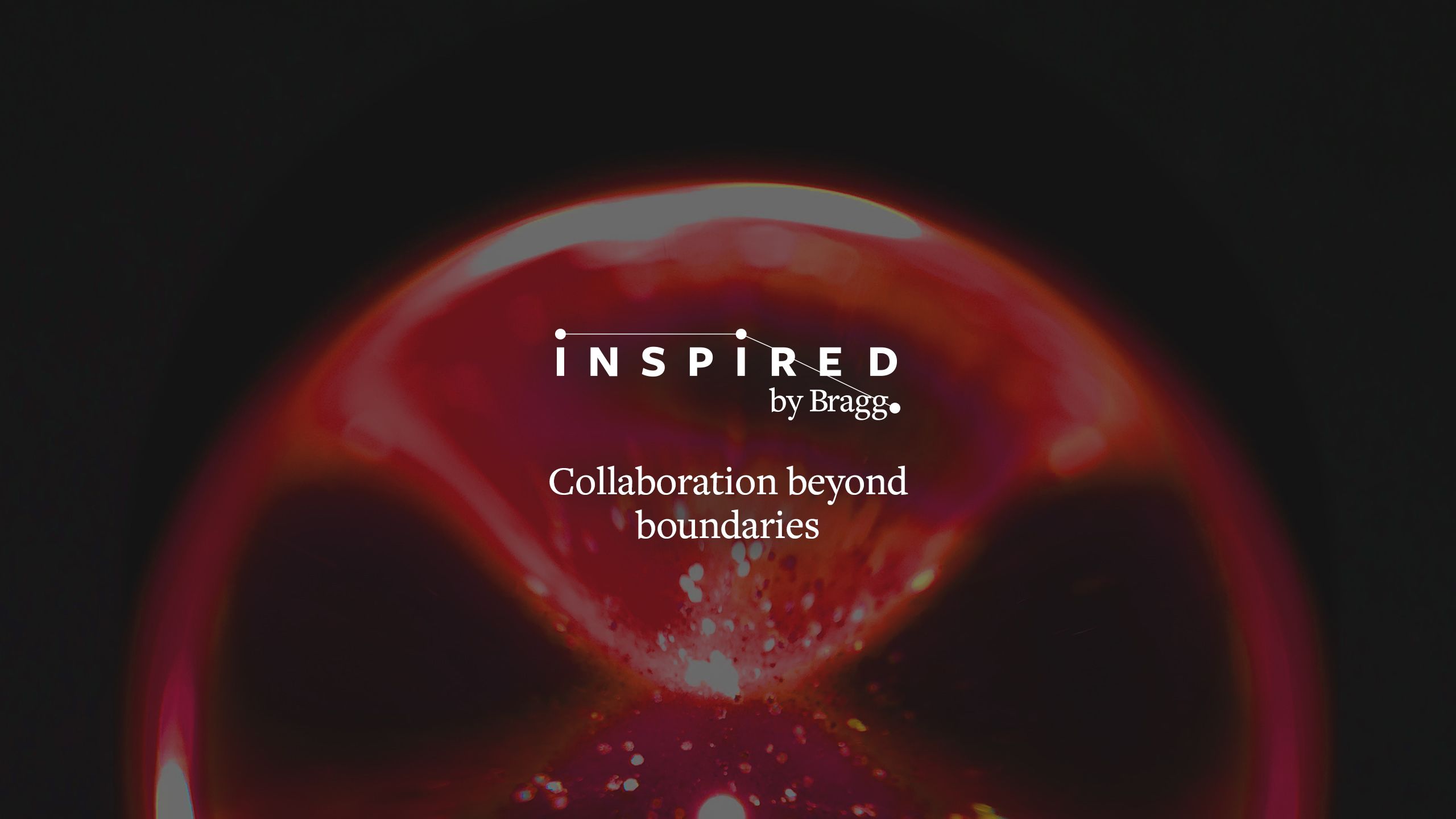 A glowing sphere with text that reads: Inspired by Bragg - Collaboration beyond boundaries.