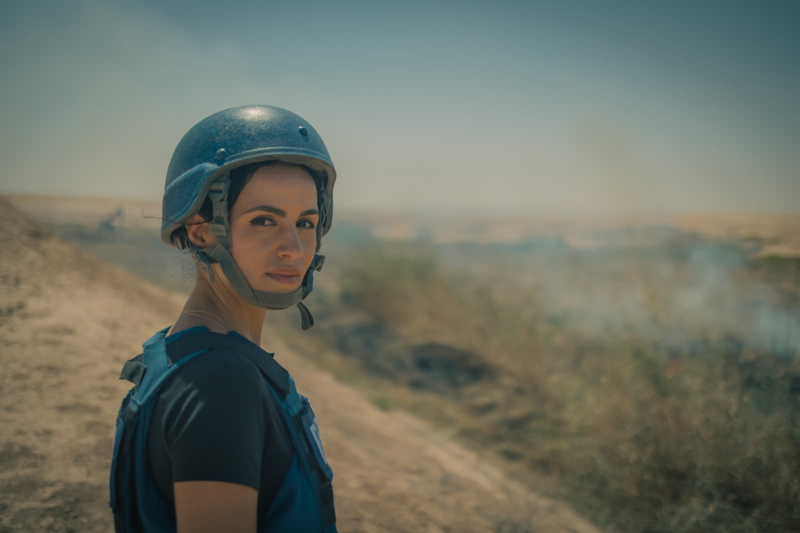 Hind Hassan wearing a Press vest and helmet in Iraq