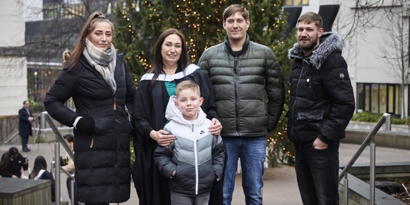 Sarah Lloyd stands with her family on graduation