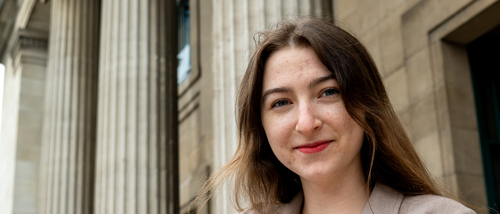 Mariia stands in front of the the Parkinson Tower in the background