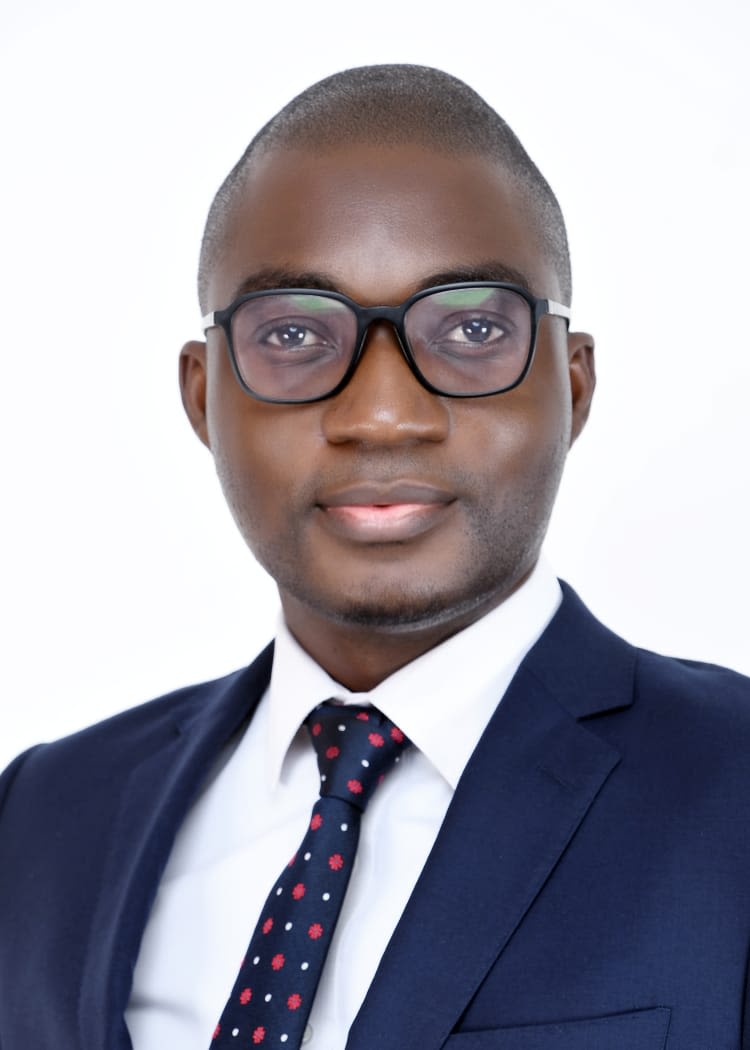 head and shoulders of man wearing glasses, tie and jacket