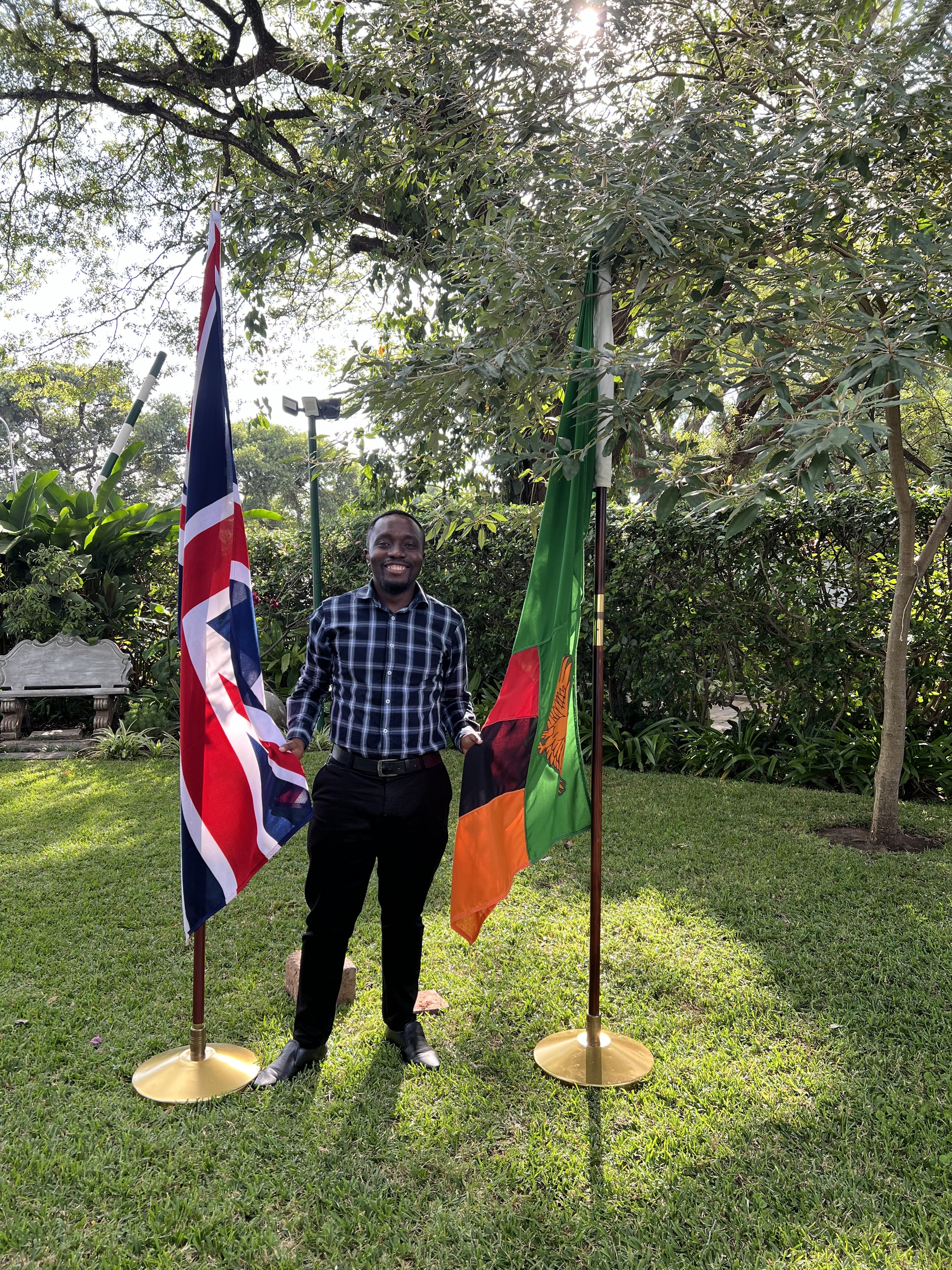 man standing between two flags