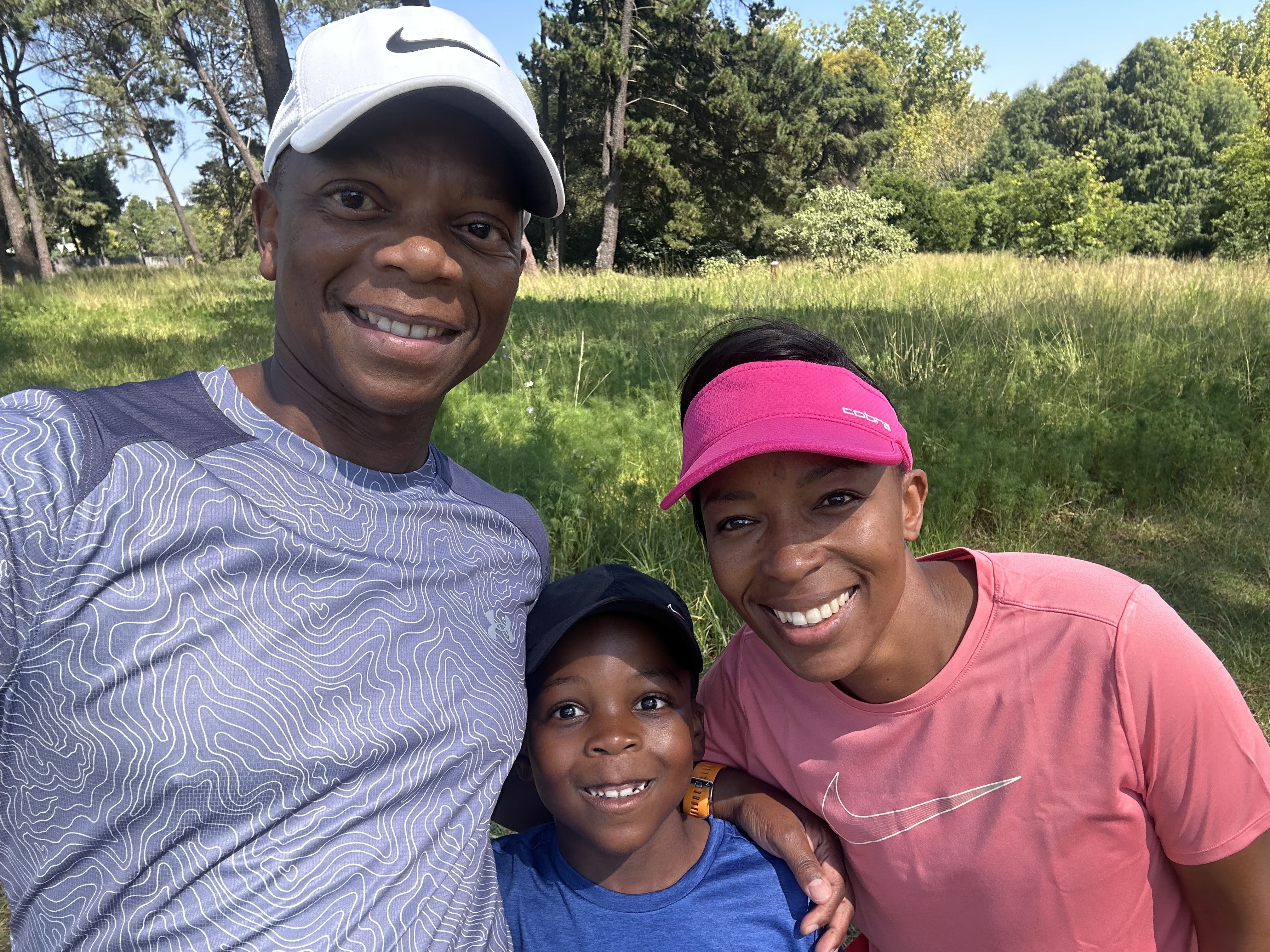 man woman and child smiling at camera