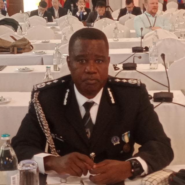 Man in police uniform sitting at table