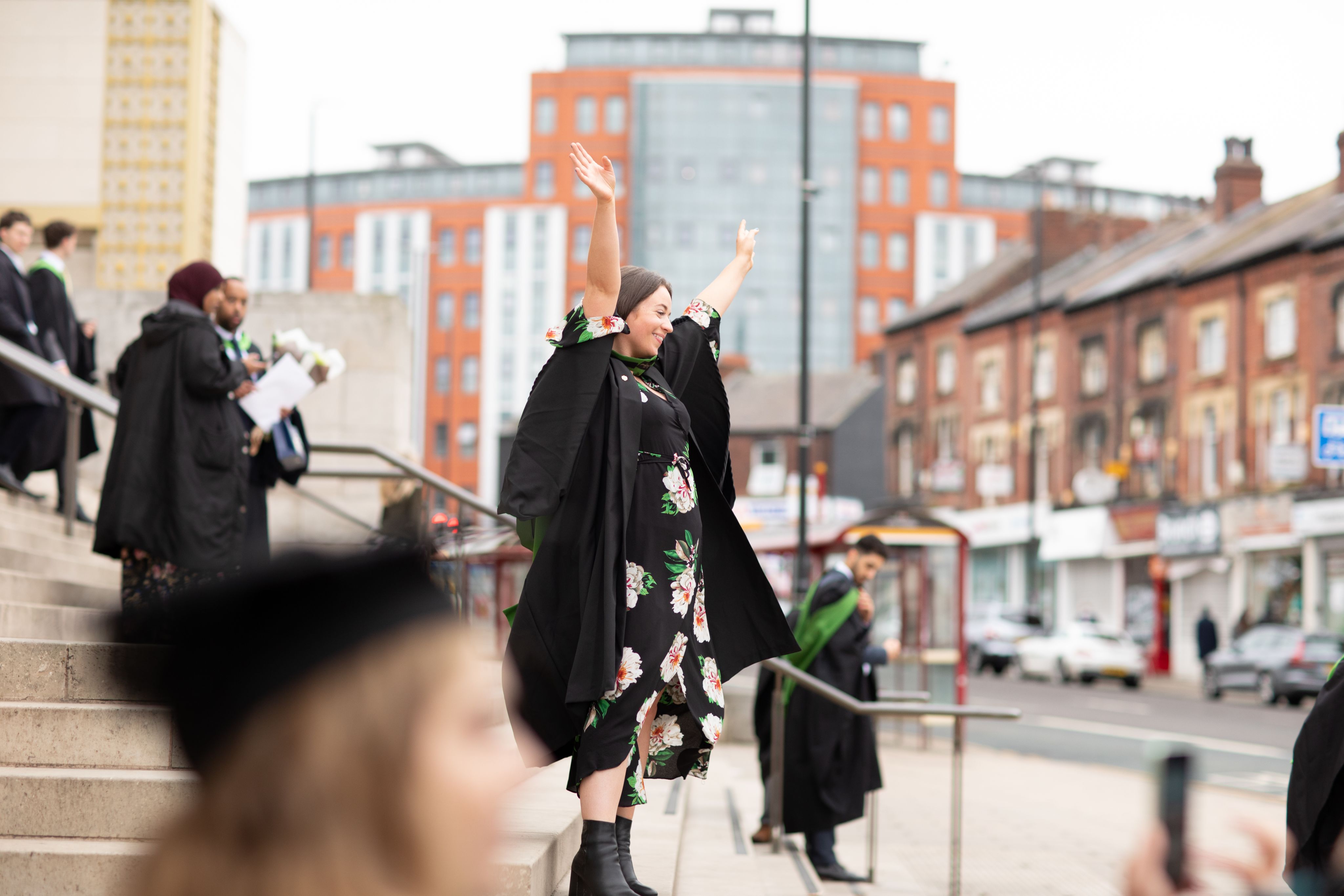 Graduate celebrates on Parkinson steps