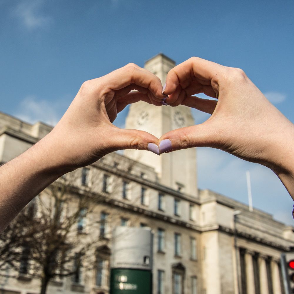 The Parkinson Building overlayed by hands forming the shape of a heart