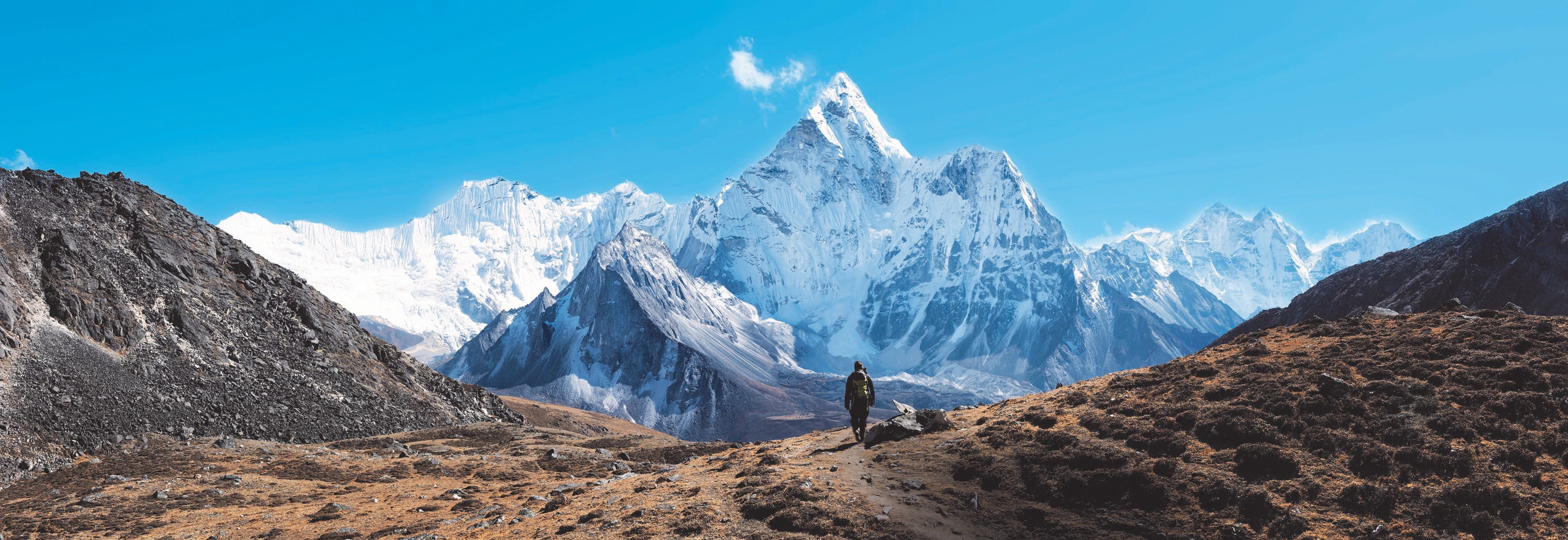 An individual walking towards the Himalayas