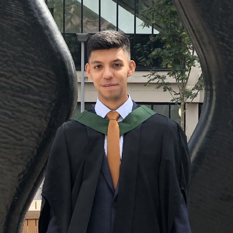Sam Tovey poses in his graduation gown