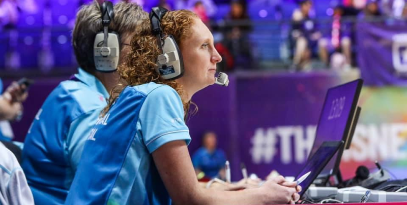 Kathy Fairclough sits at the side of the court to officiate the netball game