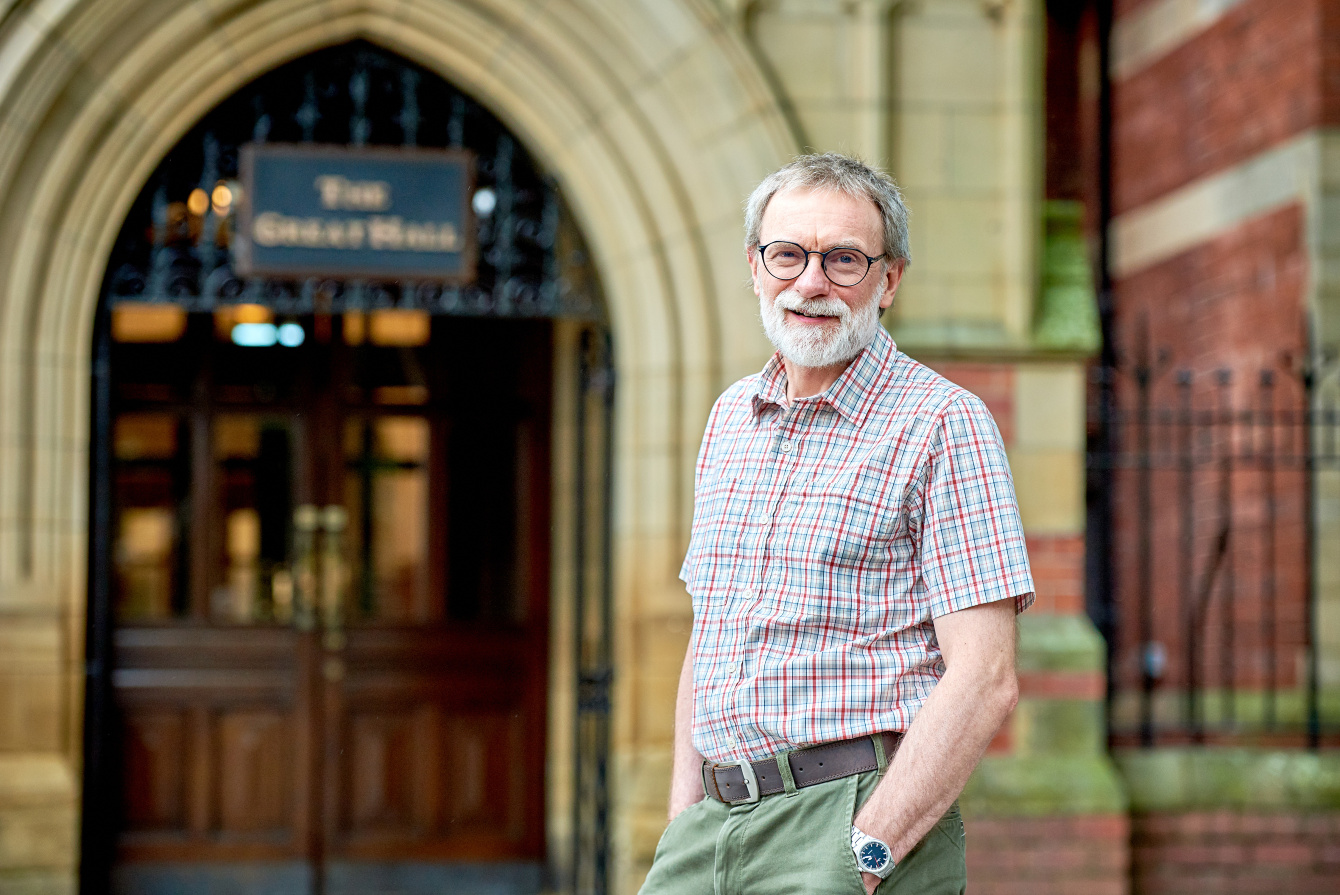 Peter Workman stands in front of the Great Hall