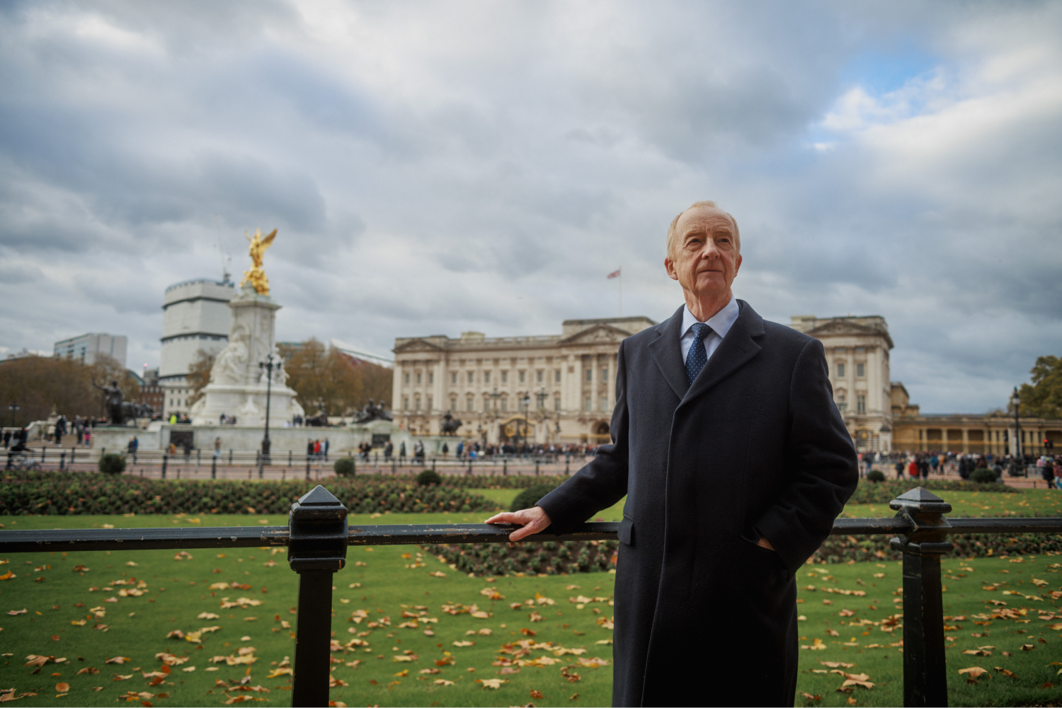 Nick Witchell stands in front of Buckingham Palace