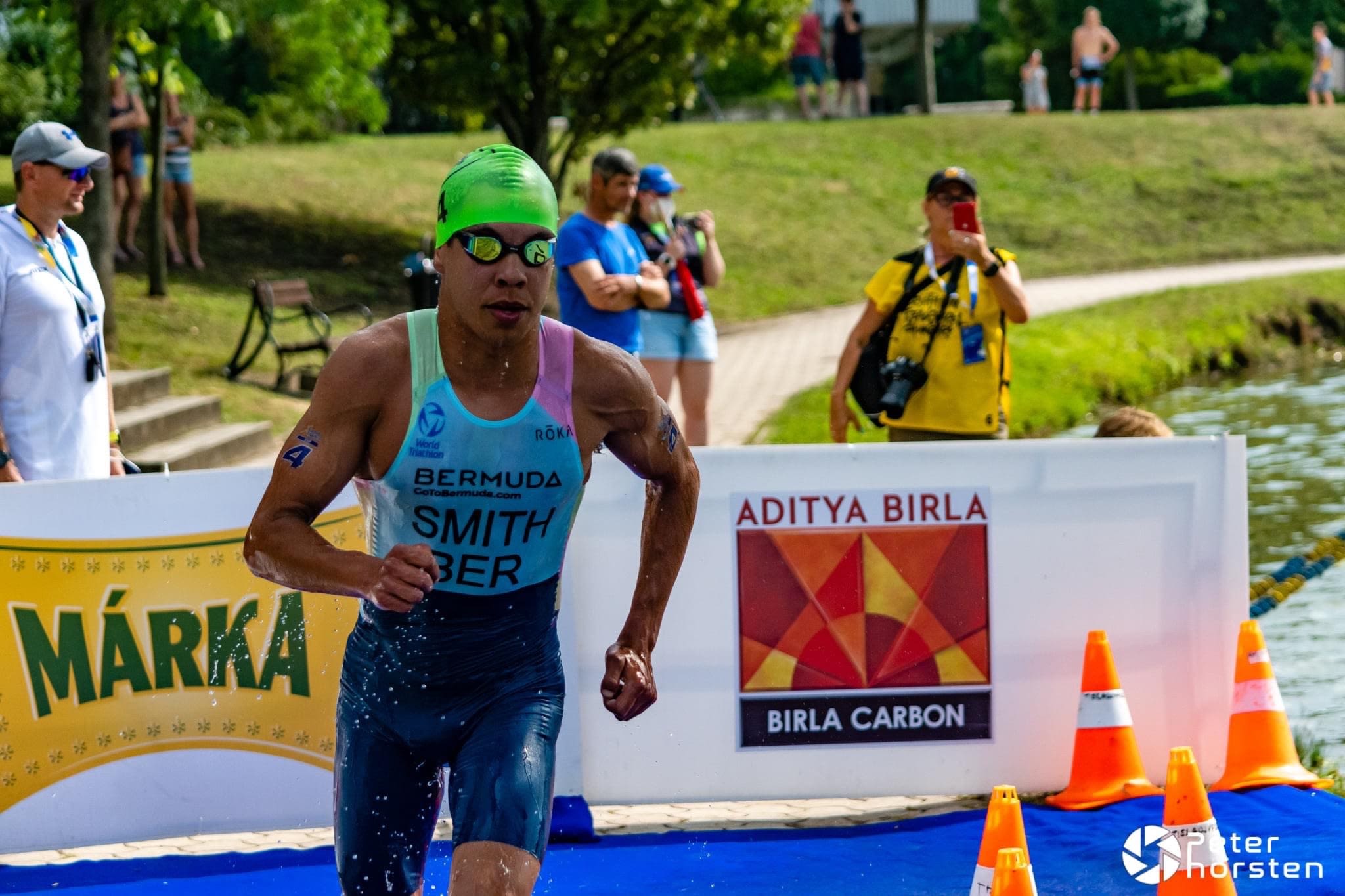 Triathlete exits water during race