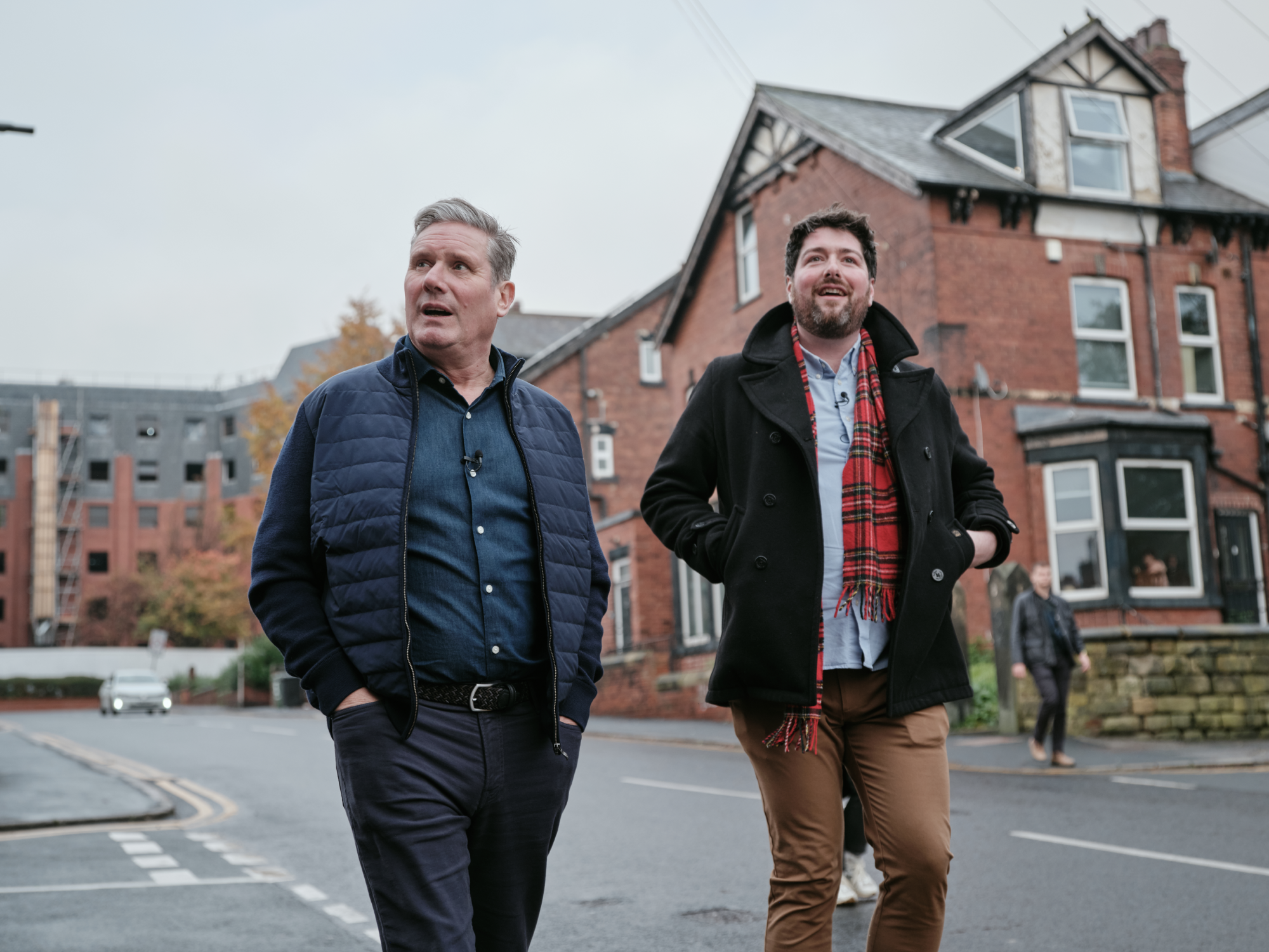 Keir Starmer and another person walking through a student residential street in Hyde Park