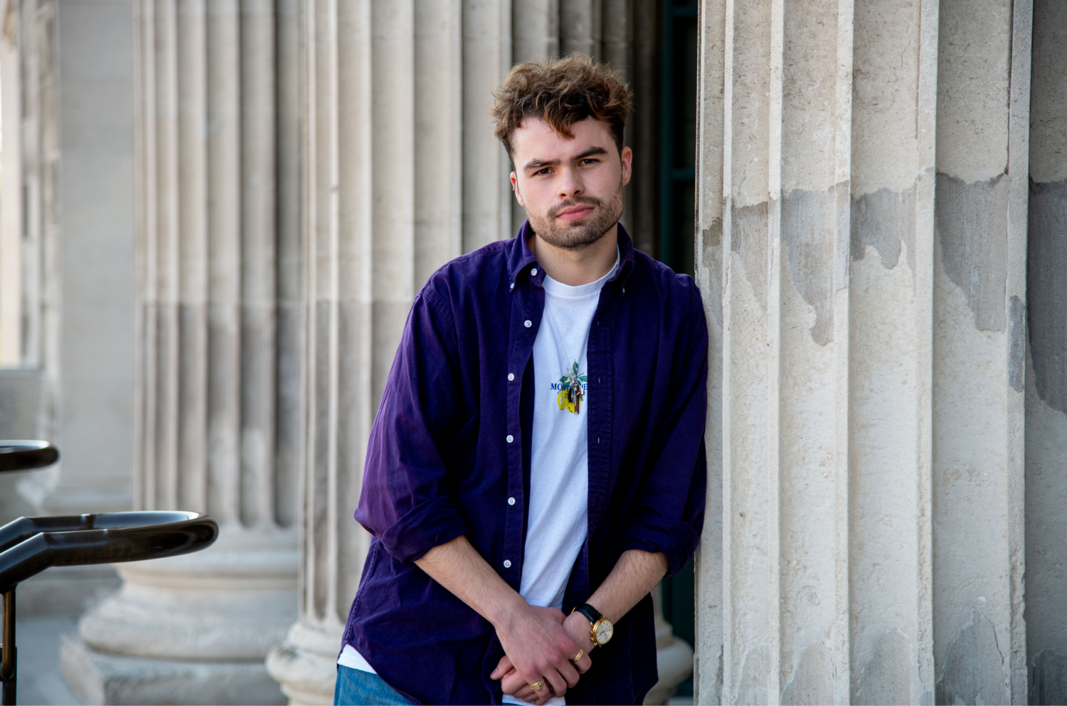 Man leans against a pillar in a profile image