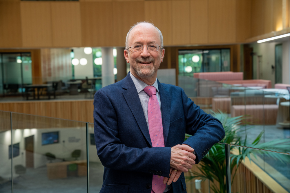 Man stands on indoor balcony for profile image