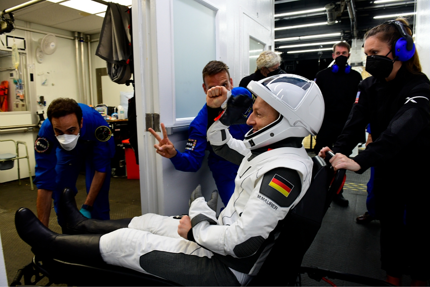 Astronaut sits in chair celebrating