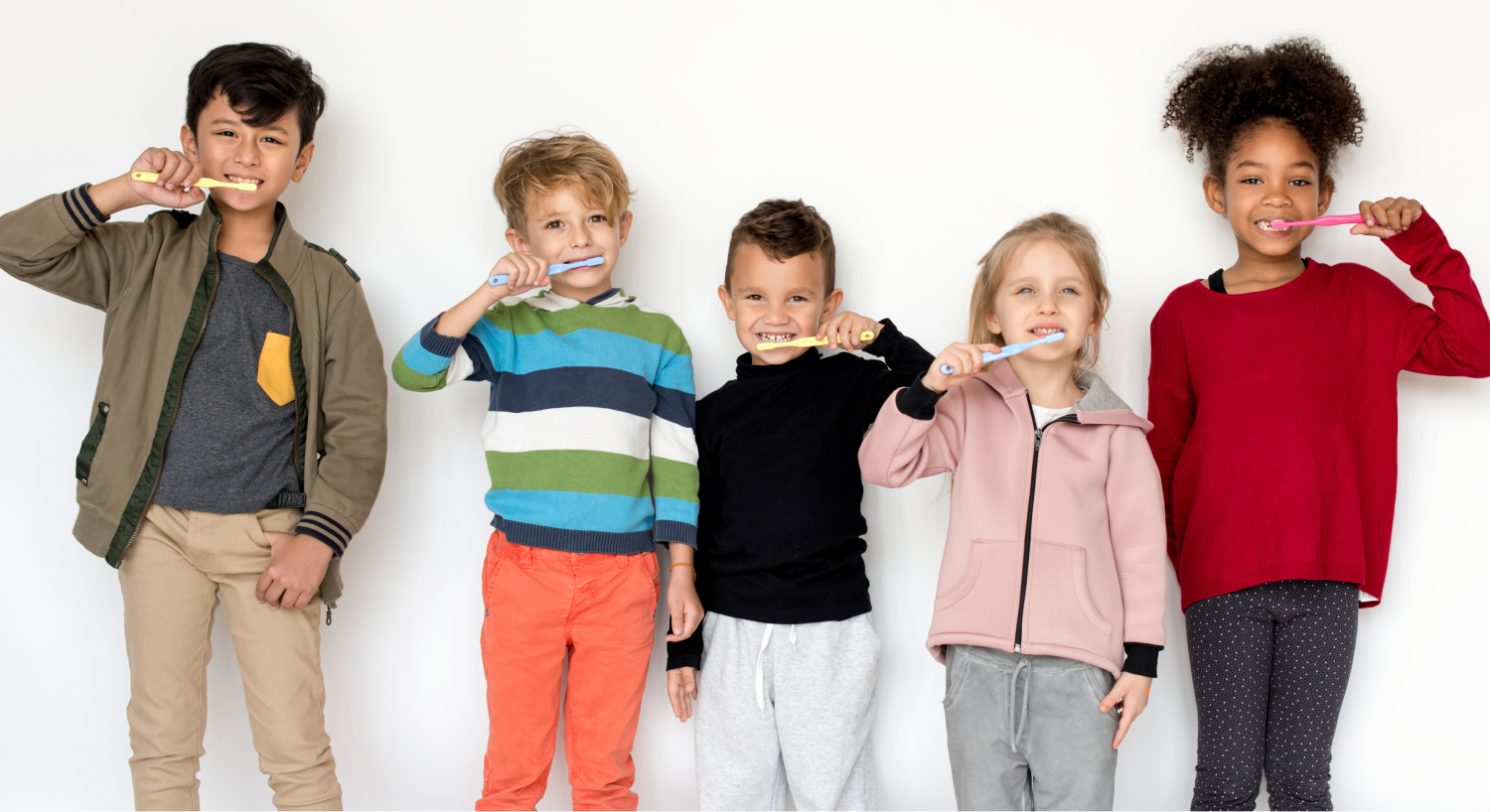 Five children stand in a line brushing their teeth