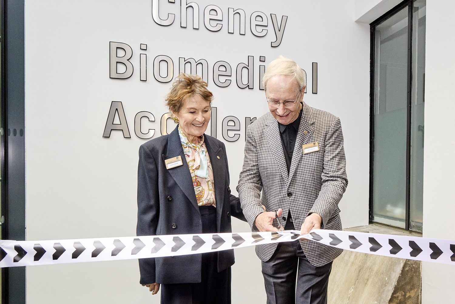 A couple cut the ribbon to open a new facility