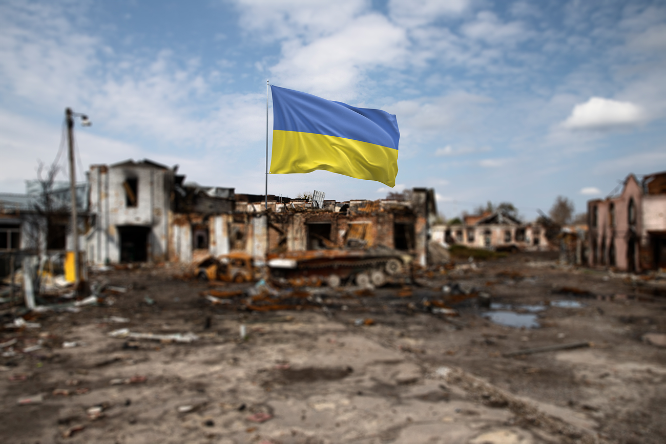 A Ukraine flag amongst the rubble of a war-torn town