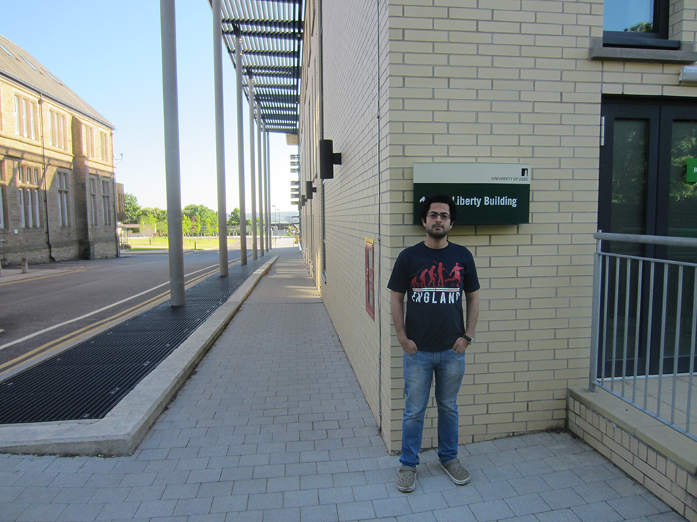 Sharique stood outside a University building