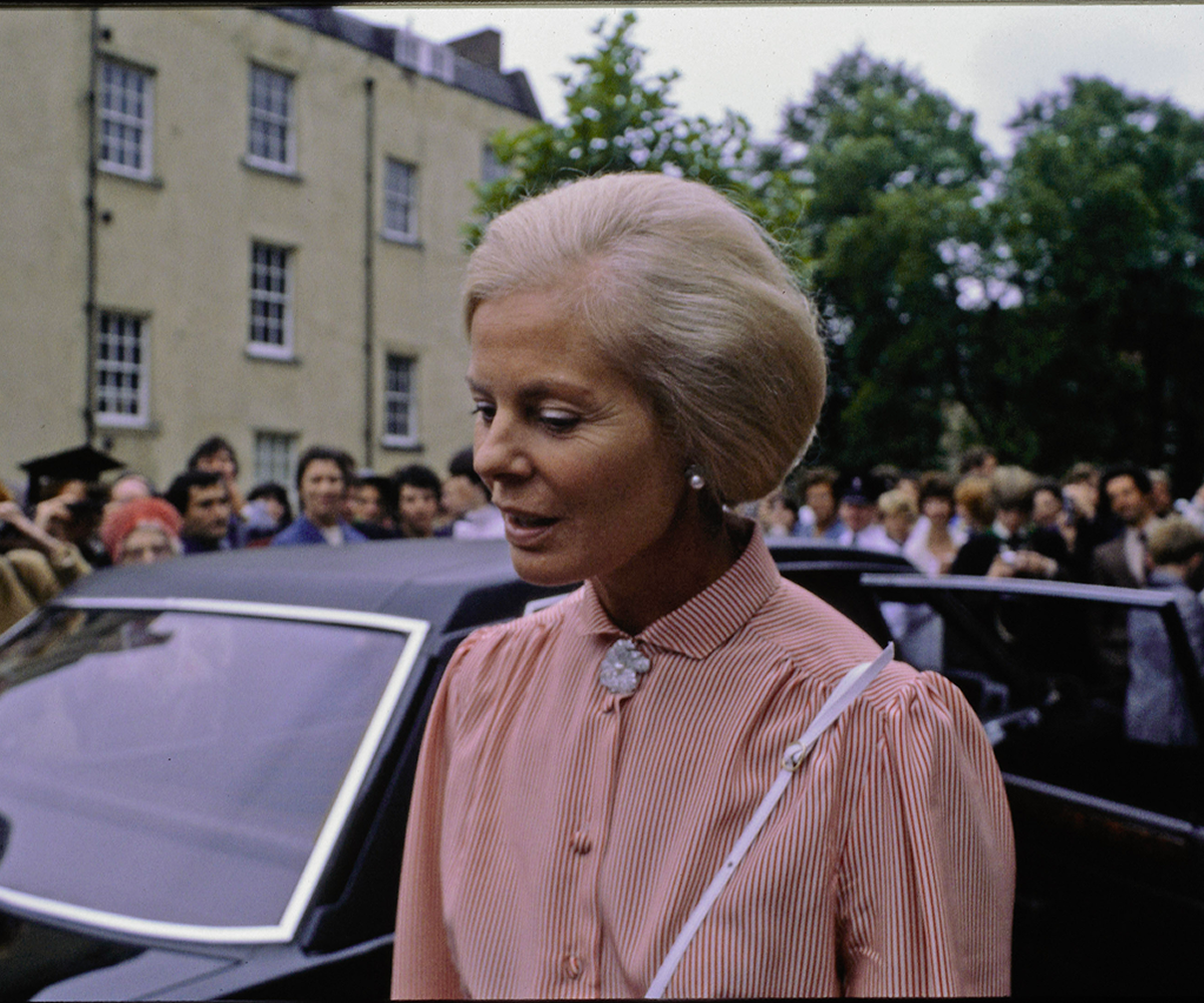 The Duchess exits a car with a crowd of onlookers watching on