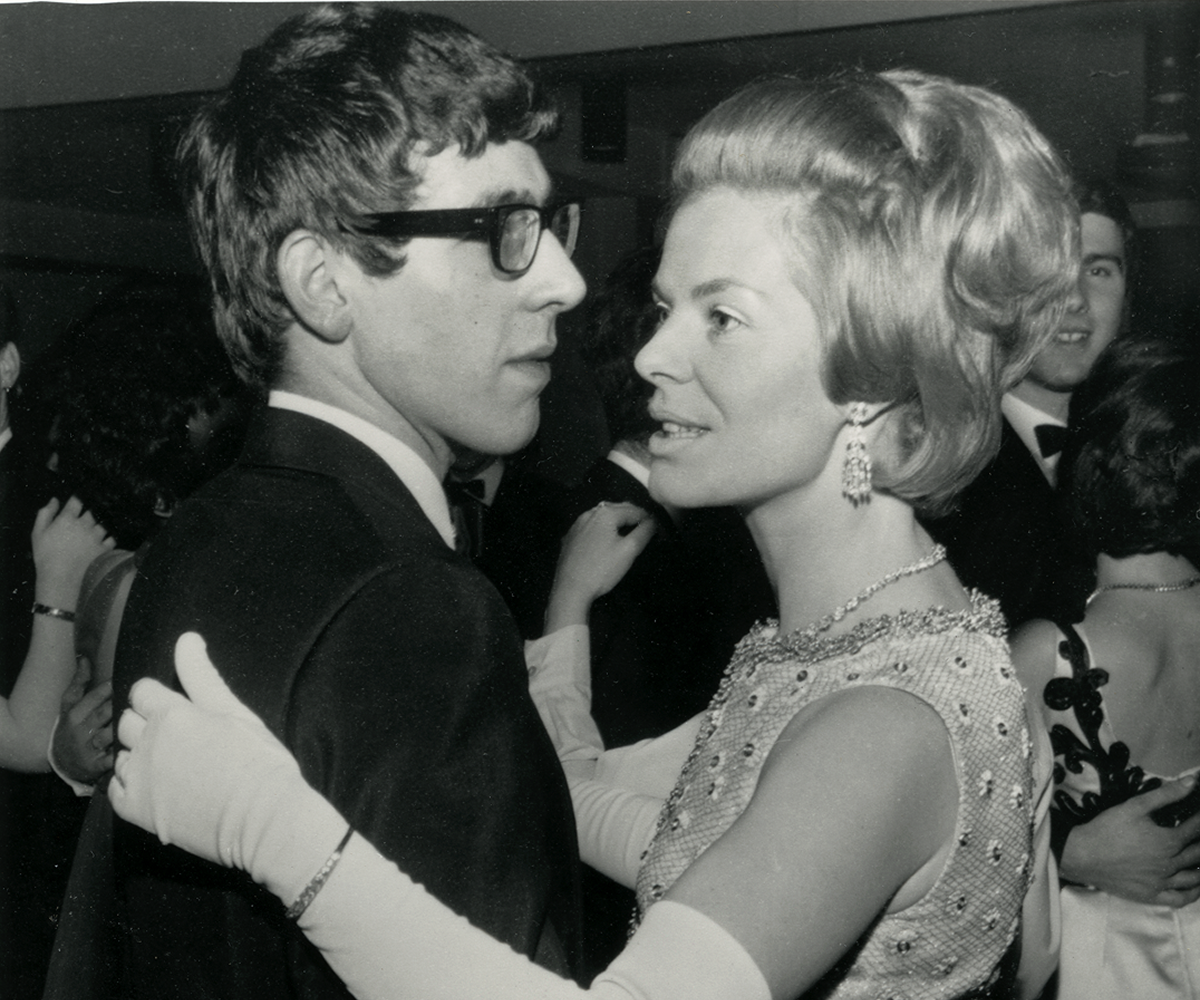 Two individuals ballroom dancing in a black and white image