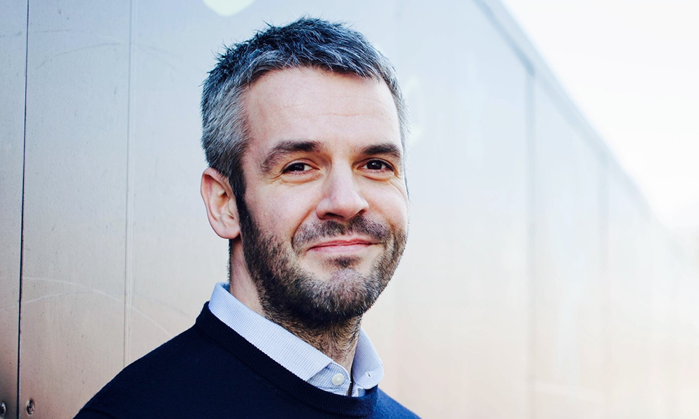 Profile image of smiling Oliver Coppard