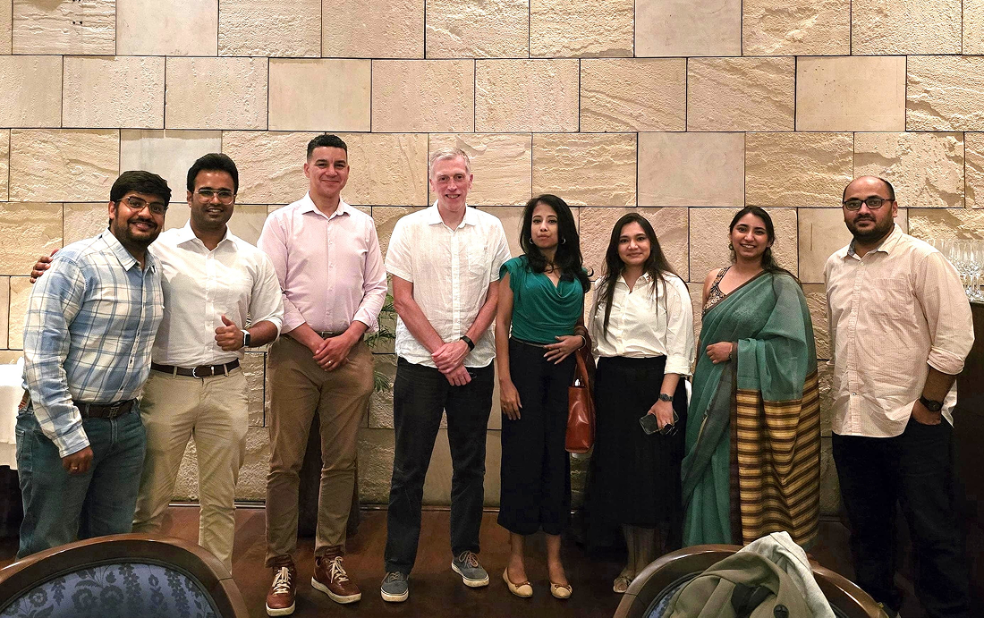 Eight individuals pose for a picture