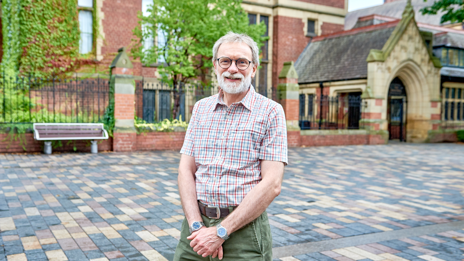 Peter Workman stands before the Great Hall at the University of Leeds