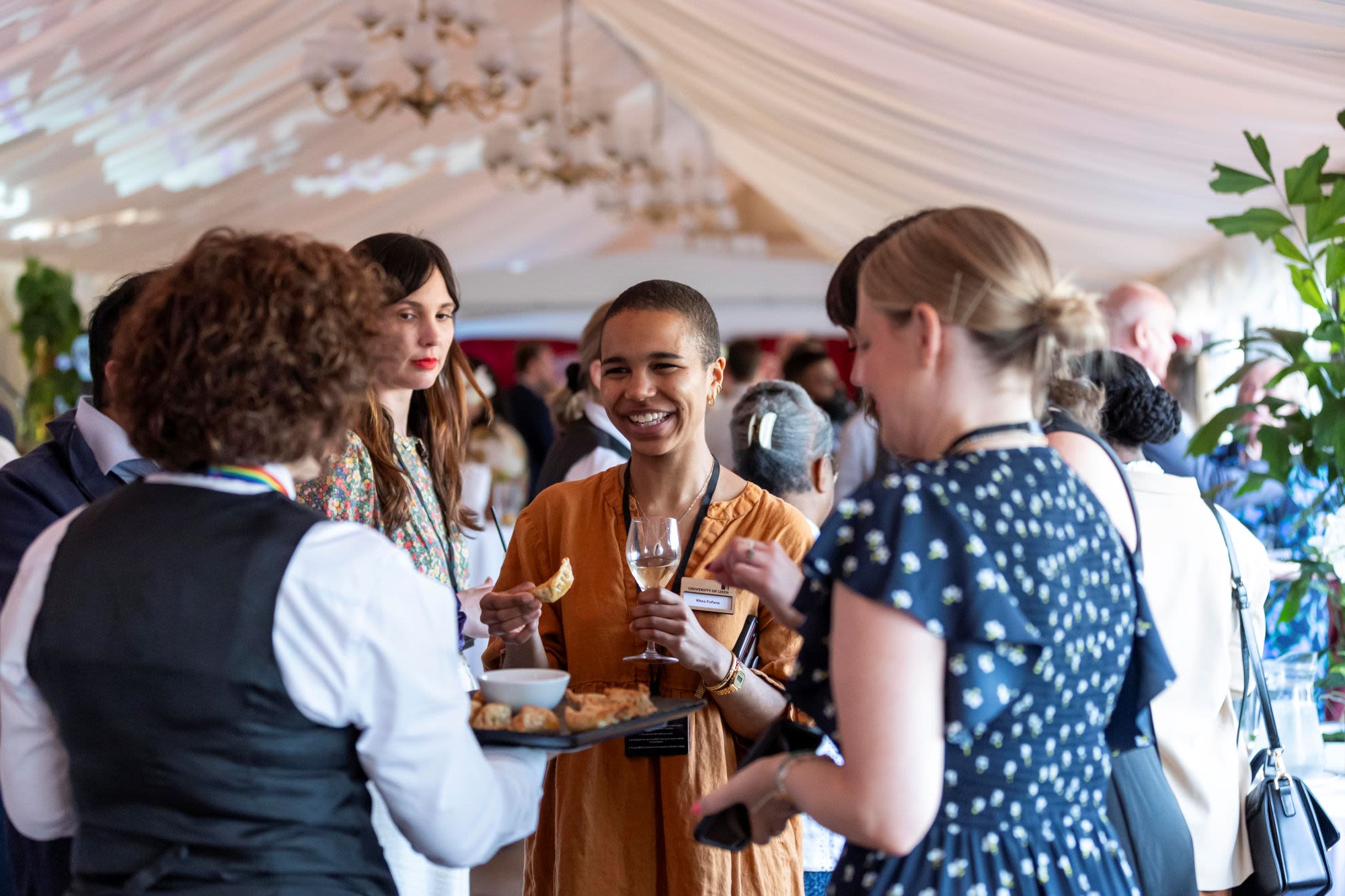 waiter serving canapes to group