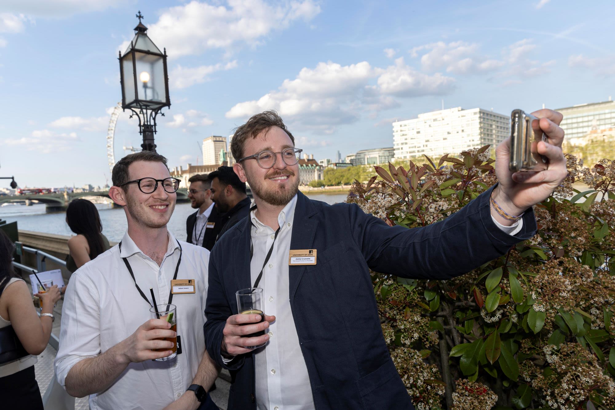 Two people taking selfie at House of Lords terrace, river behind them