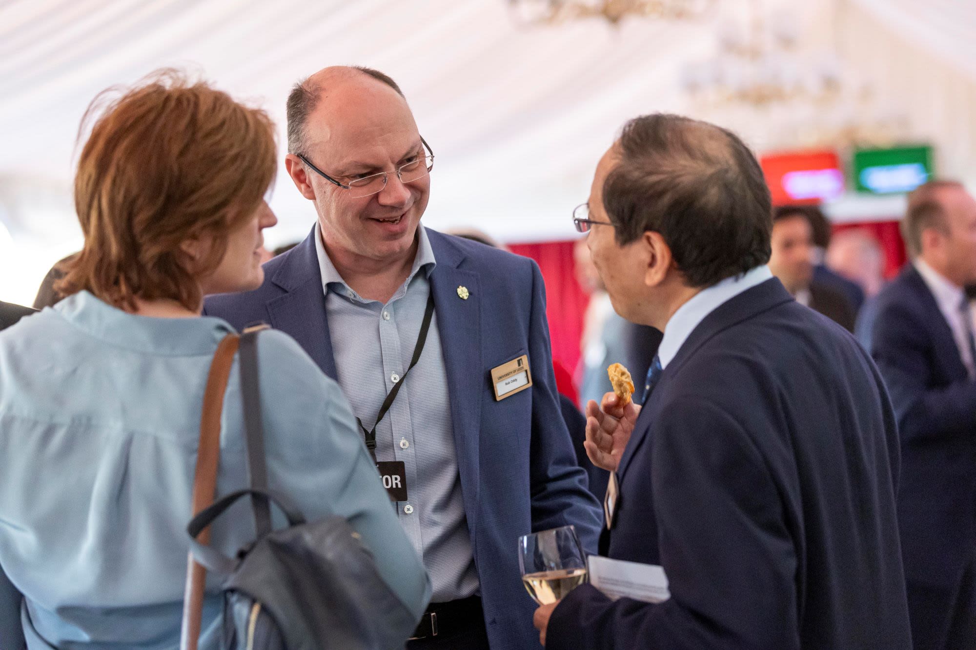 three people mingling